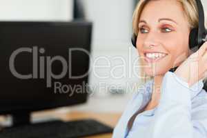 Portrait of a smiling businesswoman with headset working with co