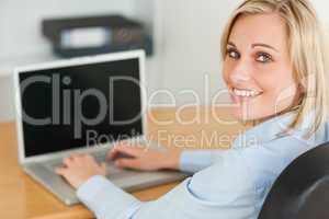 Blonde businesswoman smiling into camera