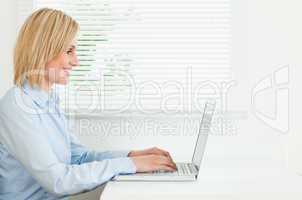 Gorgeous businesswoman working on laptop