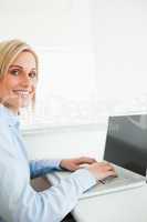 Close up of a gorgeous blonde businesswoman working on laptop lo