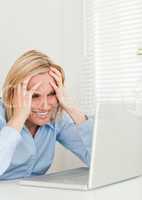 Frustrated businesswoman sitting in front of her notebook