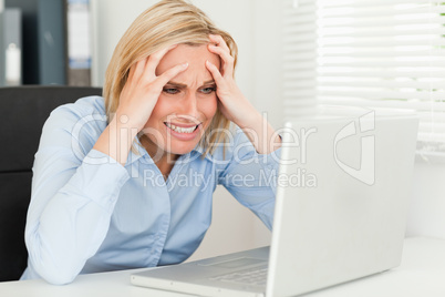 frustrated woman sitting in front of her notebook