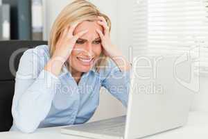 frustrated woman sitting in front of her notebook