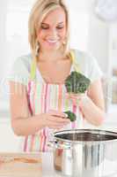 Close up of a woman cooking broccoli