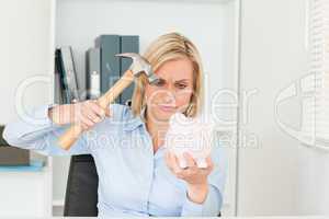 determined woman wanting to destroy her piggy bank