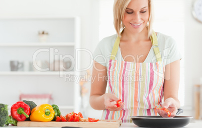 Close up of a woman frying peppers