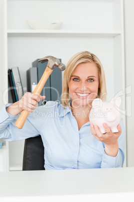 Happy woman wanting to destroy her piggy bank