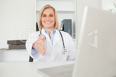 Blonde doctor giving hand