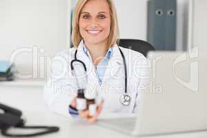Smiling doctor holding medicine