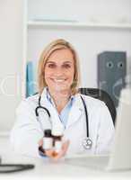 Smiling doctor showing medicine