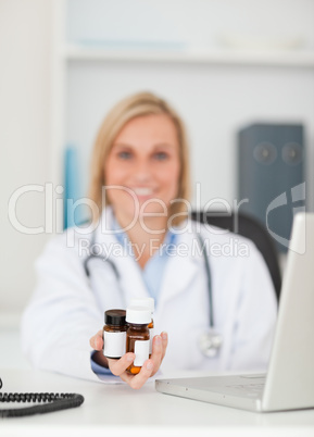 Smiling doctor presenting medicine