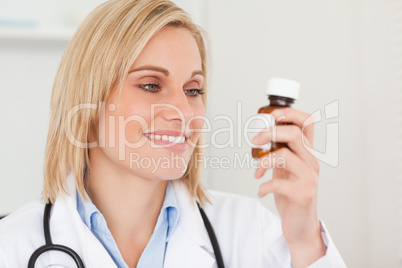 Smiling doctor looking at medicine