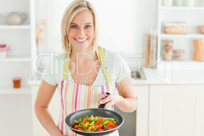 Woman with filled pan looking into the camera