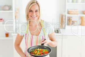 Woman with filled pan looking into the camera