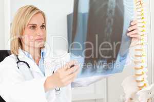 Serious doctor looking at x-ray