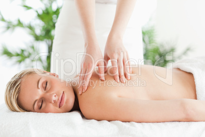 Blonde woman relaxing on a lounger during massage