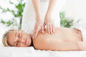 Blonde woman relaxing on a lounger during massage
