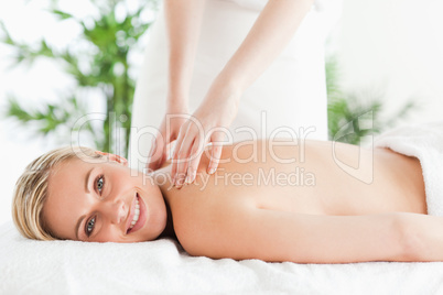 Cute woman relaxing on a lounger during massage