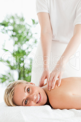 Good looking woman relaxing on a lounger during massage