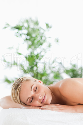 Good looking blonde woman relaxing on a lounger with eyes closed