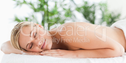Good looking blonde woman sleeping on a lounger