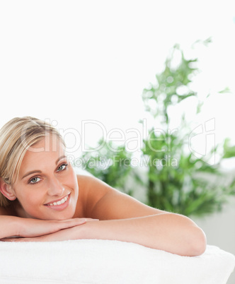 Close up of a blonde smiling woman lying on a lounger