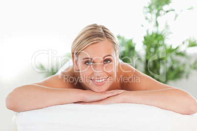 Close up of a blonde smiling woman relaxing on a lounger