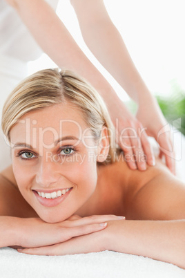 Close up of a smiling woman relaxing on a lounger during a massa