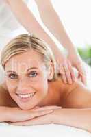 Close up of a smiling woman relaxing on a lounger during a massa