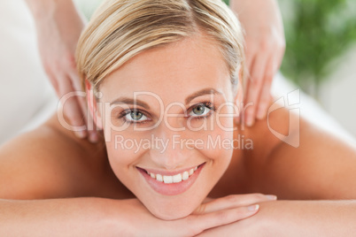 Close up of a smiling woman relaxing on a lounger during a massa