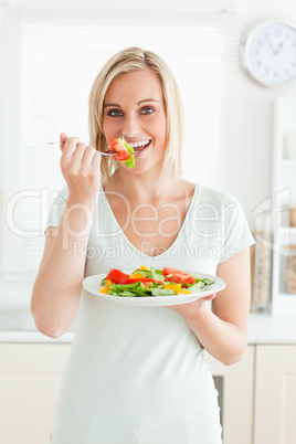 Portrait of a charming woman enjoying mixed salad