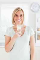 Woman holding glass filled with milk
