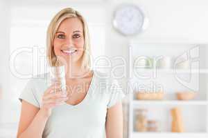 Smiling woman holding glass of water