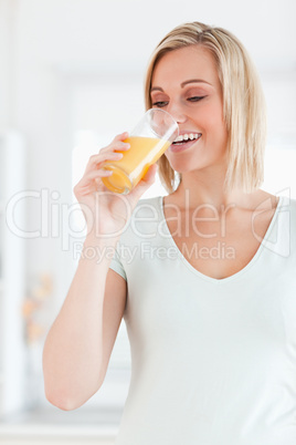 Cute woman drinking orange juice