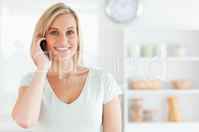 Young woman on the phone looking into the camera