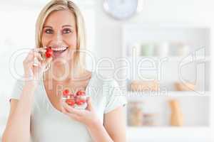 Close up of a young woman eating strawberries