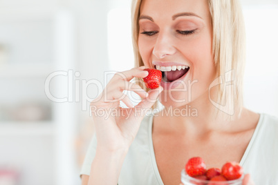 Woman enjoying eating strawberries