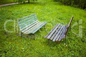 two benches on the background of green grass