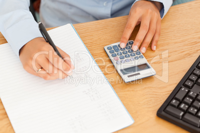 Hands of an accountant making a report