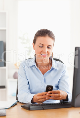 Office worker sending a text message