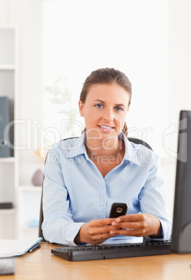 Businesswoman sending a text message