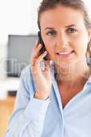 Portrait of a working woman making a phone call
