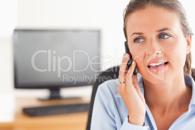 Cute working woman speaking on the phone