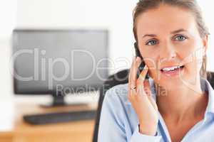 Smiling businesswoman speaking on the phone
