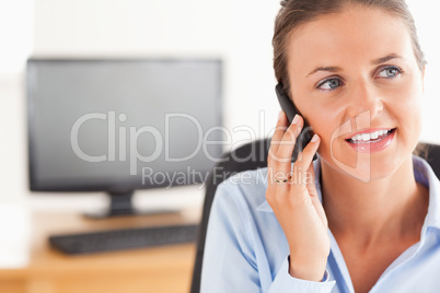 Smiling working woman speaking on the phone