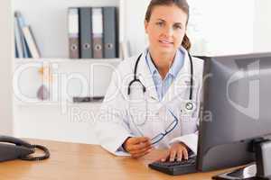 Serious doctor working with a computer