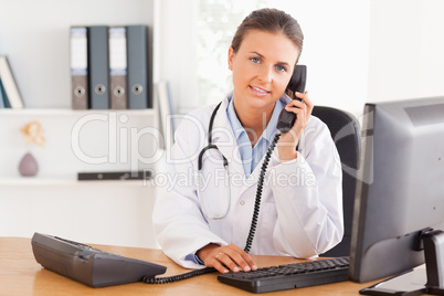 Serious female doctor on the phone