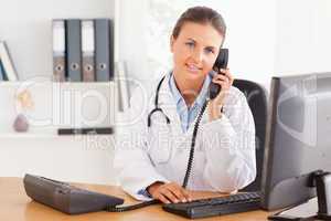 Serious female doctor on the phone