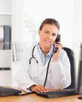 Portrait of a serious female doctor on the phone