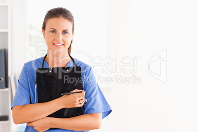 Smiling nurse holding a folder